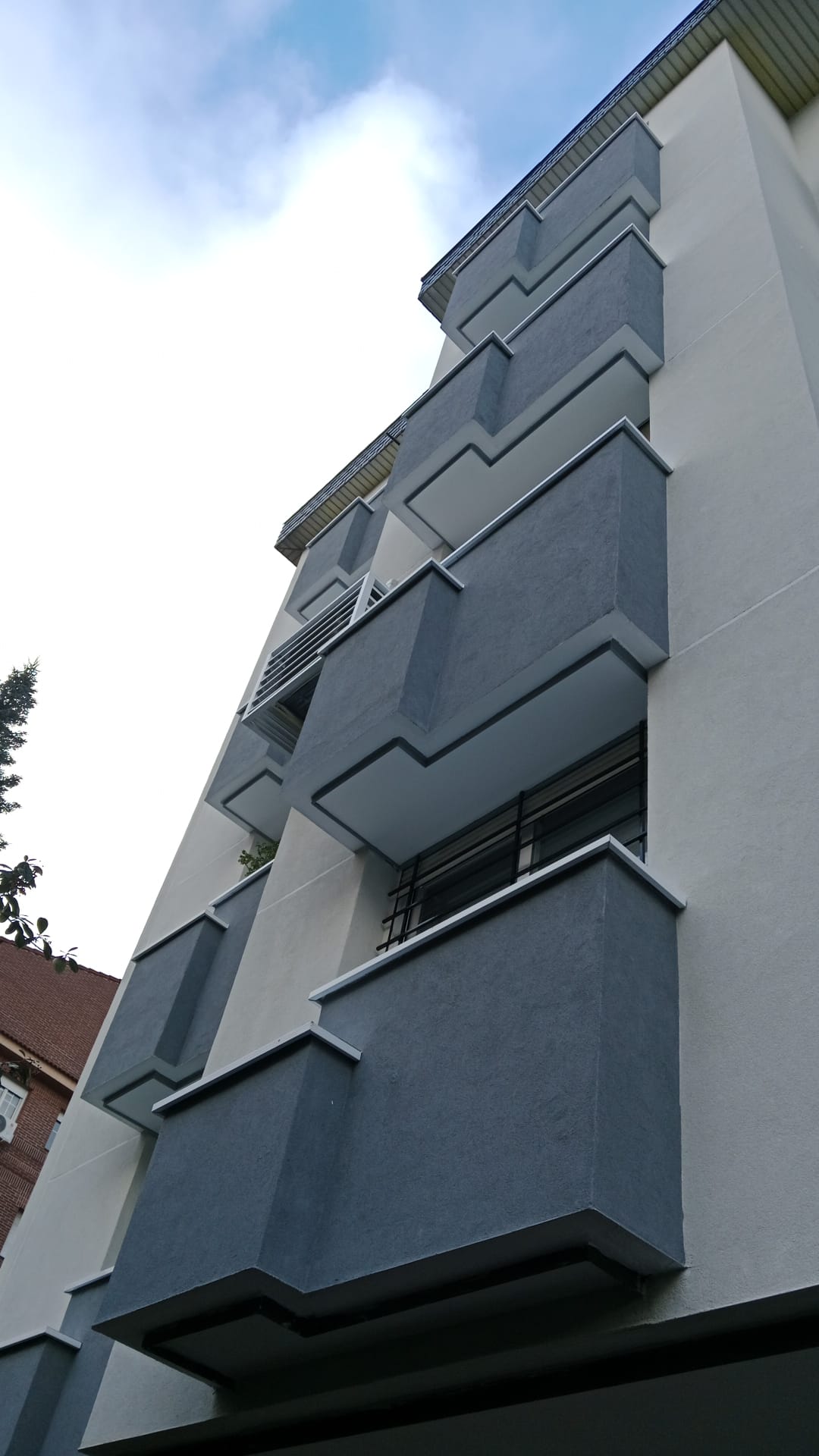 Aleixandre 4. Enero de 2026 · Detalle de los balcones con acabado gris, paños claros y remates de coronación.